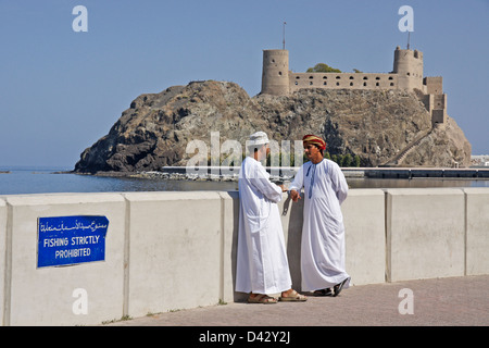 Omanische Männer sprechen vor Jalali Fort, Muscat, Oman Stockfoto