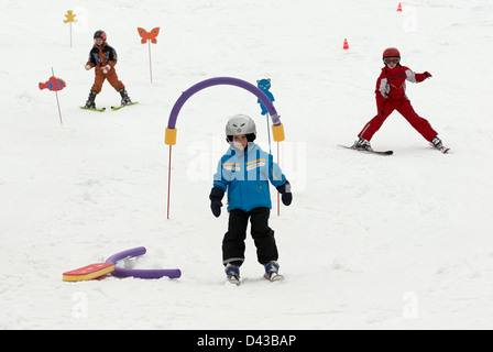 Kinder üben ihre Form in der Skischule Stockfoto