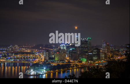 In der Nacht mit einem Mond über der Skyline von Pittsburgh, Pennsylvania, Vereinigte Staaten Stockfoto