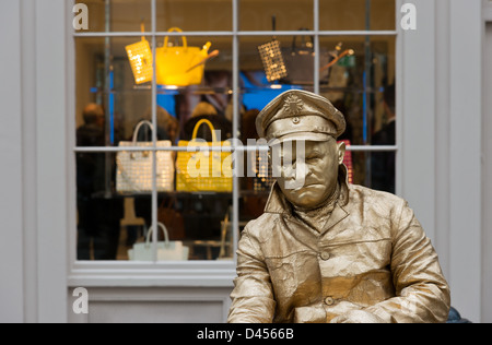 Gold lackiert männlichen Pantomime durch ein Schaufenster Covent Garden London UK Stockfoto