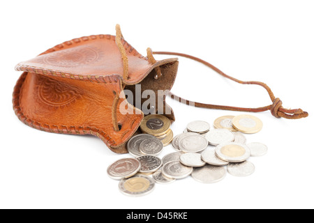 verschüttete Münzen mit Geldsack auf weißem Hintergrund Stockfoto