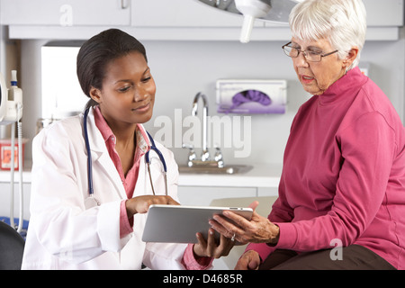 Arzt diskutieren Datensätze mit Senior Patientin Stockfoto