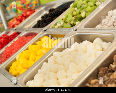 Gefrorenen Joghurt Toppings Bar. Joghurt Toppings von frischen Früchten, Nüssen, frisch geschnittenem Süßigkeiten, Sirupe und Streuseln. Stockfoto