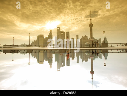 Shanghai Morgen, Leute, die auf den Bund mit Spiegelbild im Wasser Stockfoto