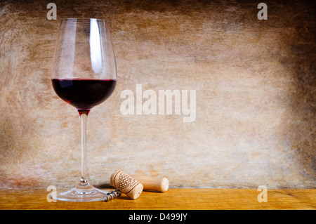 Glas Rot Wein und Kork Schraube auf einem hölzernen Hintergrund mit Text Textfreiraum Stockfoto