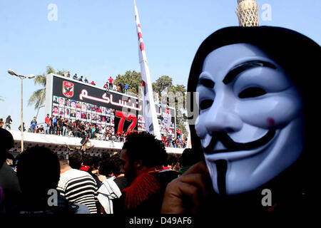 Kairo, Ägypten. 8. März 2013.  Ägyptische Fußball-Fans von Al-Ahly Club feiern vor ihrem Clublokal in Kairo. Eine ägyptische Gericht bestätigte Todesurteile gegen 21 Personen für ihre Rolle in eine tödliche 2012 Fußball-Aufstand, der mehr als 70 Menschen in der Stadt Port Said getötet. Banner im Hintergrund zeigt einige Bilder von den Opfern mit Arabisch, die liest, '' Wir werden dich nie vergessen (Bild Kredit: Kredit: Tareq Gabas/APA Images/ZUMAPRESS.com/Alamy Live News) Stockfoto