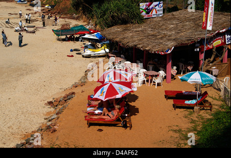 Sinquerim Beach Goa Indien Touristen Entspannung auf Schirm Strandhütte und Blick auf das Resort Stockfoto