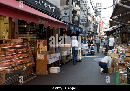 Am frühen Morgen Strassenszene gesäumt von Geschäften mit Arbeiter beschäftigt und Käufer bewegen sich in der Nähe von Tsukiji-Markt in Tokio Stockfoto