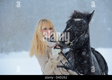 Junge Frau mit Pferd in Schnee, Oberpfalz, Deutschland, Europa Stockfoto