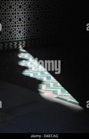 Sun die Fliesen Beleuchtung und Schatten der Bögen zu schaffen, in dem Real Alcazar in Sevilla, Spanien. Stockfoto