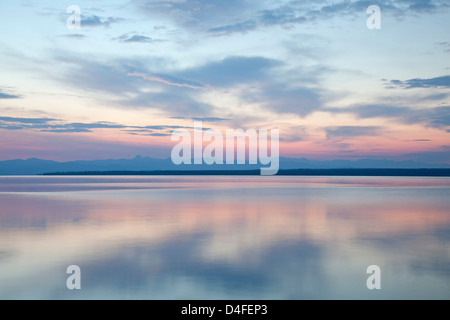 Sonnenaufgang reflektiert in stillem Wasser Stockfoto