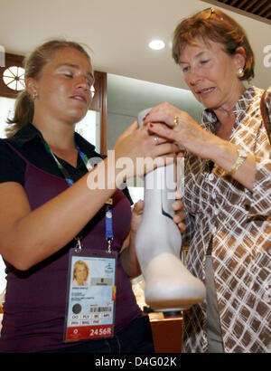 Eva Luise Koehler (R), Frau des deutschen Bundespräsidenten Horst Köhler, hilft blinde Verena Bentele, die Bein-Schiene teilweise querschnittsgelähmt Radsportler Michael Teuber während die Paralympischen Spiele 2008 in Peking, China, 7. September 2008 zu fühlen. Horst Köhler und seine Frau besuchen derzeit China für drei Tage im Rahmen seiner Asien-Reise. Sie genossen die Track cycling Wettbewerbe auf der vel Stockfoto