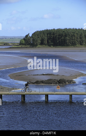 Radfahrer beim Überqueren einer Brücke über die Mündung des Flusses bawnaknockane, ballydehob, West Cork, Republik von Irland Stockfoto