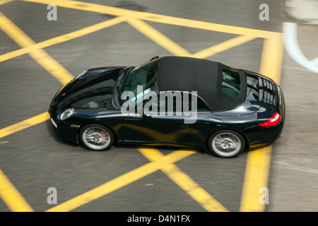 Draufsicht eines beweglichen Porsche auf einer Straße in Hong Kong. Stockfoto
