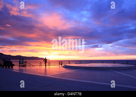 Einen herrlichen Sonnenaufgang über der Statue des spanischen Königs Alfonso XII am Balcon de Europa in Nerja an der Costa del Sol in der Provinz Malaga, Spanien Stockfoto