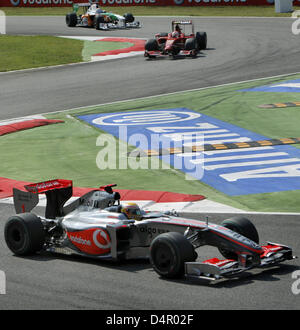 Britischen Lewis Hamilton von McLaren Mercedes steuert sein Auto vor finnischen Kimi Räikkönen der Scuderia Ferrari und deutschen Adrian Sutil von Force India in der ersten Runde des italienischen Formel 1 Grand Prix auf der Formel1 Rennstrecke in Monza, Italien, 13. September 2009. Foto: JENS Büttner Stockfoto