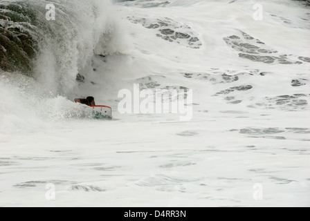 Bodyboarder schnitzen eine Linie durch das Wildwasser in stürmischen Brandung an der Keil in Newport Beach, Kalifornien, USA. Stockfoto