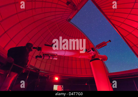 In der Sternwarte macht ein Astronom Beobachtungen mit einem großen Refraktorteleskop am 3RF Astronomie Campus in Texas. Stockfoto