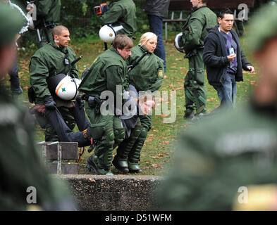 Polizeikräfte in Aufruhr Getriebe entführen eine Person, die gegen stark protestierten umstritten Railway Station Projekt Stuttgart 21 auf einen Baum in Stuttgart, Deutschland, 30. September 2010. Der besetzte Baum ist Bestandteil einiger 300 Bäume, die im Rahmen der stark umstrittenen 4,1 Milliarden-Euro-Projekt gefällt werden ' Stuttgart 21', die eine Umwandlung des Stuttgarter Hauptbahnhofs aus sieht Stockfoto