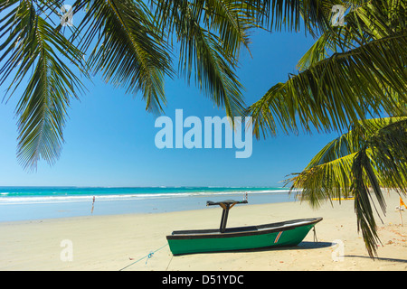 Boot am palmengesäumten Strand von dieser entspannten Dorf & Resort, Samara, Provinz Guanacaste, Nicoya Halbinsel, Costa Rica Stockfoto