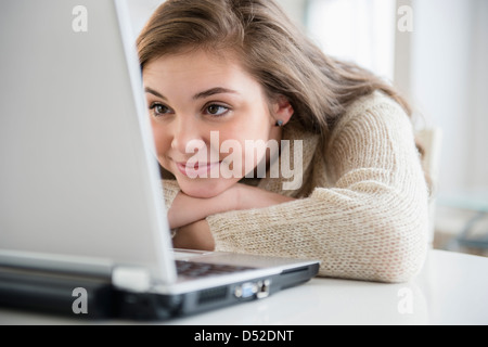 Hispanischen Mädchen mit Laptop am Schreibtisch Stockfoto