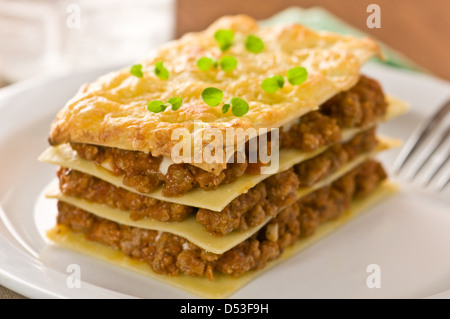 Stück Lasagne auf weißen Teller Stockfoto