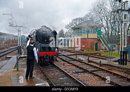 Der Bluebell Railway, Sussex, UK am ersten Tag der Gala feiert die Erweiterung East Grinstead. Hier ist der "9F" Lok nähert sich Horsted Keynes. Der Stellwerkswärter soll das Token mit der Feuerwehrmann austauschen. Stockfoto