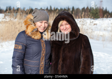 Porträt von zwei kaukasischen fröhlichen Frauen in warme Kleidung im freien Stockfoto