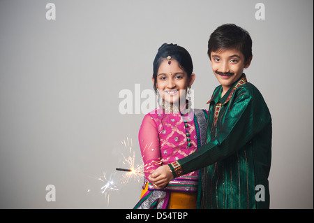 Zwei Kinder imitieren wie paar feiern Diwali-fest mit Wunderkerzen Stockfoto