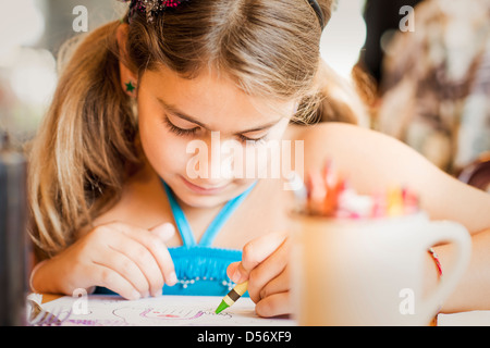 Gemischte Rassen Mädchen Färbung am Schreibtisch Stockfoto