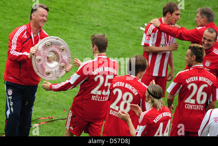 Bayern Trainer Louis van Gaal (L) Hände leiten Thomas Mueller die Trophäe für den Gewinn der deutschen Meisterschaft nach deutschen Bundesliga-Spiel Hertha BSC Berlin Vs FC Bayern München im Olympiastadion Berlin, Deutschland, 8. Mai 2010. München, gewinnt das Match mit 3: 1 und feiert ihren 22. Deutsche Meistertitel, während Berlin 2. Division abgestiegen ist. Foto: HANNIBAL Stockfoto