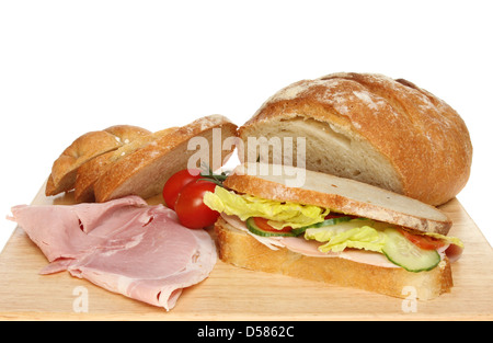 Nahaufnahme eines frisch gebackenen Bloomer Laib, Sandwich mit Schinken und Tomaten auf einem Holzbrett Stockfoto