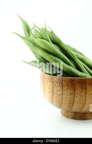 Frische Bohnen Obst in Holzschale auf weißem Hintergrund. Stockfoto
