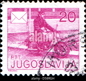 Jugoslawien - CIRCA 1986: Briefmarke gedruckt in Jugoslawien zeigt Postbote auf Fahrrad, ca. 1986 Stockfoto