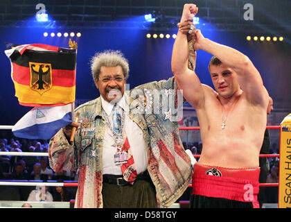 Belarussische Boxer Sergey Liakhovich (R) feiert seinen Sieg bei der Universum Champions Night Schwergewichts-Veranstaltung neben Box-Promoter Don King in Rostock, Deutschland, 22. Mai 2010. Liakhovich besiegte nicaraguanischer Boxer Evans Quinn (nicht abgebildet). Foto: Bernd Wuestneck Stockfoto