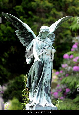 Eine Engelsfigur auf dem Ohlsdorfer Friedhof in Hamburg, Deutschland, 1. Juni 2010 abgebildet. Der Friedhof wurde als ein Landschaftspark von Wilhelm Cordes im Jahre 1877 auf 400 Hektar geplant. Zwei Buslinien bedienen auf 17 Kilometer auf dem Friedhof, der größte Grünfläche der Stadt ist. Bisher wurden einige 1,4 Millionen Beerdigungen. Foto: Maurizio Gambarini Stockfoto