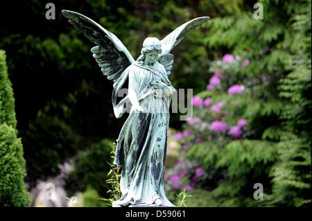 Eine Engelsfigur auf dem Ohlsdorfer Friedhof in Hamburg, Deutschland, 1. Juni 2010 abgebildet. Der Friedhof wurde als ein Landschaftspark von Wilhelm Cordes im Jahre 1877 auf 400 Hektar geplant. Zwei Buslinien bedienen auf 17 Kilometer auf dem Friedhof, der größte Grünfläche der Stadt ist. Bisher wurden einige 1,4 Millionen Beerdigungen. Foto: Maurizio Gambarini Stockfoto