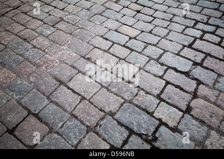 Hintergrundtextur des alten Granit gepflasterten Straße Stockfoto