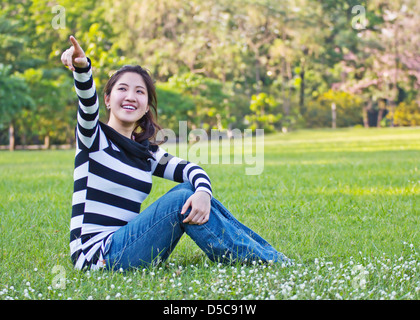 Asiatische Frau zeigt den Baum Stockfoto