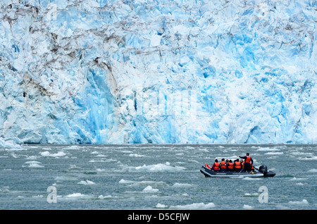 Touristen auf einem kleinen Boot am Fuße des North Sawyer Gletscher in Alaska der Tongass National Forest. Stockfoto