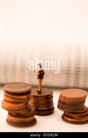 Zahlen von Geschäftsleuten auf Münzen Stockfoto