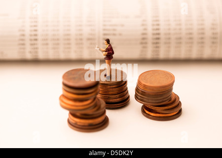Figuren der Geschäftsmann auf Münzen Stockfoto