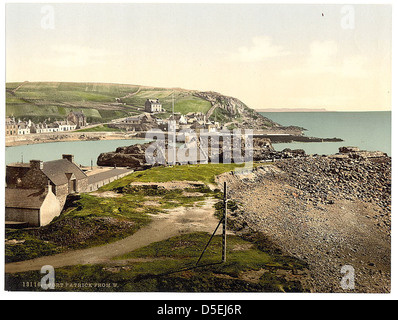 Ein malerischer Blick auf Port Patrick, Schottland, von Westen aus erfasst. Diese malerische Stadt ist bekannt für ihren Hafen, malerische Küstengebäude und die raue Schönheit der umliegenden Landschaft. Das Foto zeigt die ruhige Uferpromenade der Stadt und die zerklüfteten Klippen entlang der Küste. Stockfoto