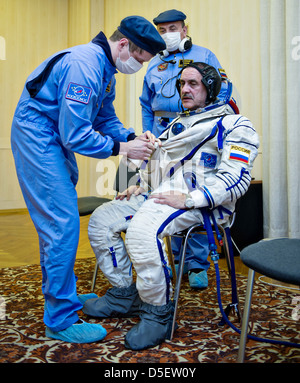 Expedition 35 Sojus Commander Pavel Vinogradov wird in seine russische Sokol geholfen zu entsprechen, vor seiner Markteinführung auf der Sojus-Rakete auf der internationalen Raumstation ISS am Weltraumbahnhof Baikonur 28. März 2013 in Baikonur, Kasachstan. Stockfoto