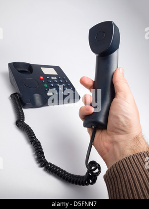 Hand halten Telefonhörer Stockfoto