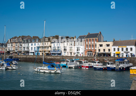 Boote vertäut im Hafen Stadt von Ilfracombe, Devon, UK, Hirsts Restaurant Nr. 11 Kai (rot zugemauert im Hintergrund) Stockfoto