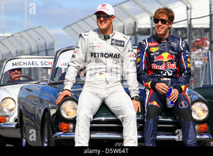 Datei - eine Archiv Bild datiert 18. März 2012 zeigt deutsche Formel1 Rennfahrer Michael Schumacher (L) des Team Mercedes AMG und Sebastian Vettel von Red Bull-team bei der Fahrerparade vor dem GP Australien in Melbourne, Australien. Formel 1 Weltmeister Vettel hat bereut den Rückzug der Rekord-Weltmeister Michael Schumacher am Ende der laufenden Saison. Stockfoto