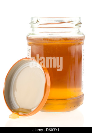 Glas mit flüssiger Honig mit der Spitze entfernt Stockfoto
