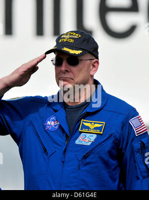 Alan Poindexter, Kommandant der Mission STS-131 begrüßt wie die Nationalhymne während der Zeremonie, wo das Space Shuttle Discovery unterzeichnet wird über das Space Shuttle Enterprise bei der Smithsonian Institution Steven F. Udvar-Hazy Center in Chantilly, Virginia zu ersetzen gesungen wird, auf die Ankunft der auf Donnerstag, 19. April 2012. Unternehmen werden in der ständigen Ausstellung Stockfoto