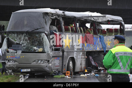 (Datei) - Notfall-Seelsorge steht neben einem abgerissenen polnischen Tourbus nach einem Unfall an der Berliner Ringautobahn in der Nähe von Rangsdorf, Germany, 26. September 2010. Eineinhalb Jahre nach der Unfall das Landgericht Potsdam Prozess gegen die Frau eröffnet, die angeblich die Ursache des Unfalls. Die 38 Jahre alte Frau wird von fahrlässiger Tötung in 14 Fällen vorgeworfen. PH Stockfoto